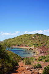 Fototapeta na wymiar Natural landscape of Playa de Cavalleria (Mercadal) in Minorca beach with clear blue sky and rocky seashore- Menorca, Spain