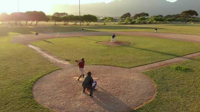 Television footage of  two teams of diverse male baseball players on baseball field