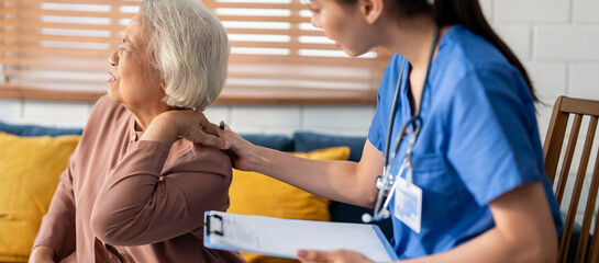 Asian caregiver nurse examine senior female patient with backache. 