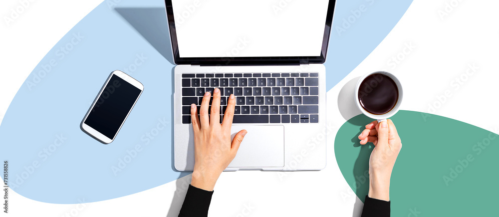 Poster person using a laptop computer from above
