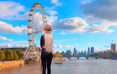 A woman in black dress standing and watching thames river - Blured the London Eye on the river...