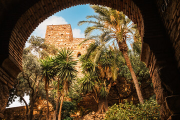 Puerta de los Cuartos de Granada (Gate of Granada Quarters) framed by the Moorish arch of Puerta del Cristo (Christ Gate), Alcazaba of Malaga, Andalusia, Spain