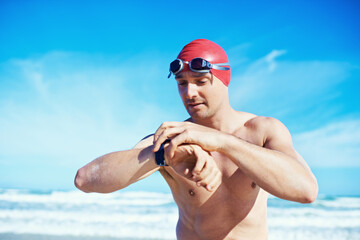 Sea, swimming and time of a man with a watch for heart rate, wellness and fitness app for sport....