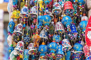 Bundles of multicolored porcelain bells and pomegranates. House decoration and amulets. Colorful...