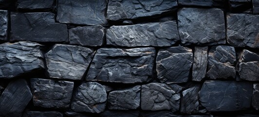 Fototapeta premium Volcanic rock bricks wall texture. Volcanic basalt bricks wall. Wall of Volcanic rock bricks wallpaper. Horizontal format for banners, posters, advertising.