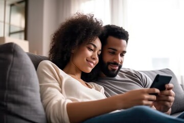 shot of a couple using their smartphone while sitting on the sofa at home