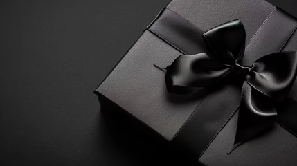 Poster Image of a Part of Luxury gift box with black bow on black, empty copy space © Uwe