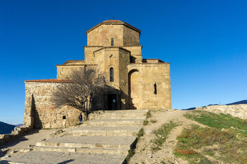 Fototapeta na wymiar Jvari monastery on the hill. Blue clear sky on background.
