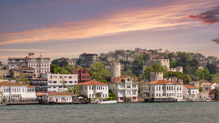 View of asian side of Bosphorus Strait with ruins of Anadoluhisari Castle in the background, a 14th century fortress built by the Ottoman Sultan Bayezid I, Istanbul, Turkey