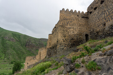 Fototapeta na wymiar Khertvisi fortress. Defence towers and walls made from stone.