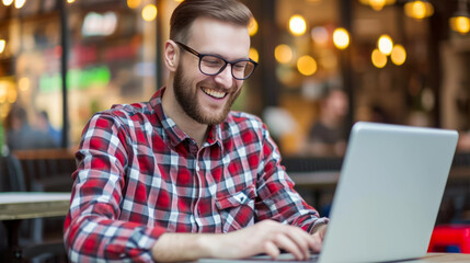 Obraz premium Man in plaid shirt smiling during an online conference at a city cafe. Freelance work culture. Generative AI