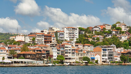 Fototapeta na wymiar Morning view from the sea of the mountains of the Europian side of Bosphorus strait, with traditional houses and dense trees in a summer day, Istanbul, Turkey