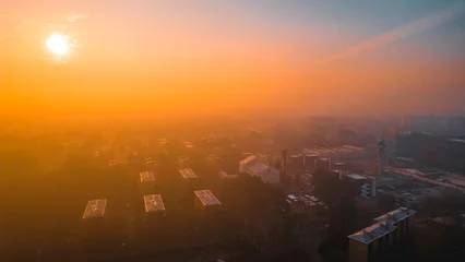 Fototapete Rund Dawn and fog over the city as seen from a drone. Lombardia, Milano, Italia © Andrew