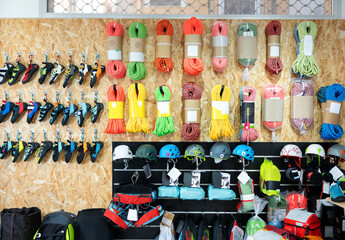 Various tourist and sports equipment on the shelves of a sports store