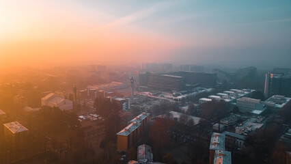 Foggy sunrise with San Donato Milanese Skyline from a drone, Lombardia, Milano, Italia 5.02.2024