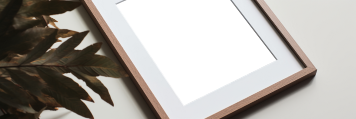 In this close-up mockup, a wood frame is elegantly displayed against a clear background, lying on a white table, offering a perfect setting for showcasing your artwork in a realistic manner.