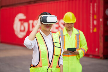 worker or engineer wearing virtual reality glasses(VR) in containers warehouse storage