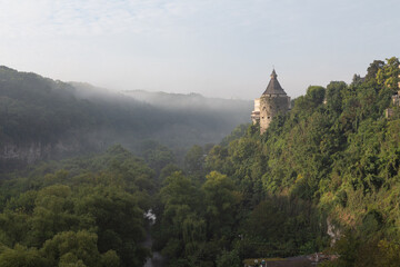 A view of the historic "Pottery" tower above the Smotrych canyon in the fog. Kamianets-Podilskyi. Ukraine