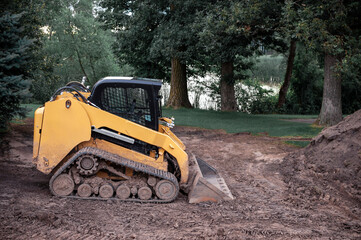 bulldozer or dozer or crawler, machine equipped with blade for pushing material soil, sand, snow,...