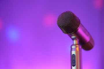 close up vertical karaoke microphone with colorful bokeh