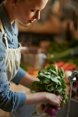 Washing, vegetables and woman in kitchen for healthy food, hygiene and cooking or preparation by...