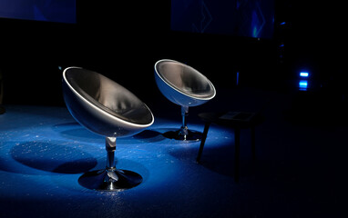 Debate or discussion - two empty chairs on stage with spotlights