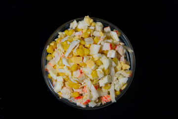 salad of corn, eggs, cabbage and crab sticks. view from above