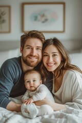 Obraz premium Smiling young parents with their baby on a bed, sharing a joyful family moment