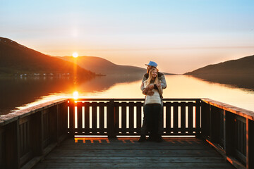 Valentines Day celebration: Romantic couple in love man and woman hugging on pier enjoying sunset view. Dating outdoor lovers relationship family travel lifestyle, lake and mountains landscape - 731612663