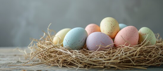 Pastel easter eggs arranged in a hay nest.