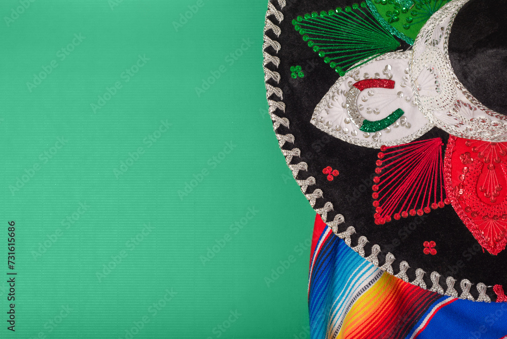 Wall mural mariachi hat and serape on green background. mexican independence concept. cinco de mayo background. - Wall murals