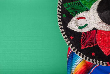 Mariachi hat and serape on green background. Mexican independence concept. Cinco de mayo background.