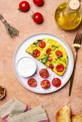 Frittata with tomatoes and spinach. Italian cuisine. Vegetarian food.