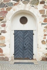 An old wooden door on a stone wall.