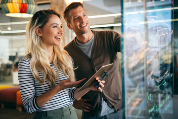 Close up diverse colleagues using tablet together, discussing online project