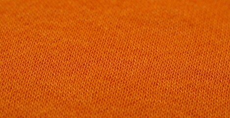 Texture of soft orange fabric as background, closeup