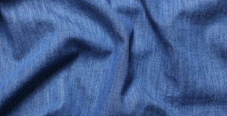 Texture of blue crumpled fabric as background, top view