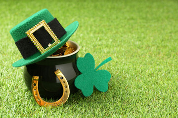 St. Patrick's day. Pot of gold with leprechaun hat, horseshoe and decorative clover leaf on green...