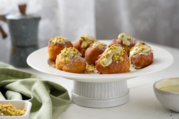 Elegant Pistachio Cream Fritelle on Pedestal Dish