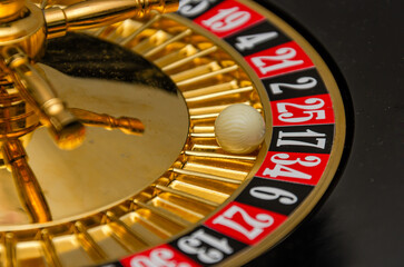 Casino roulette wheel with red and black numbers, close-up, black number 17 win