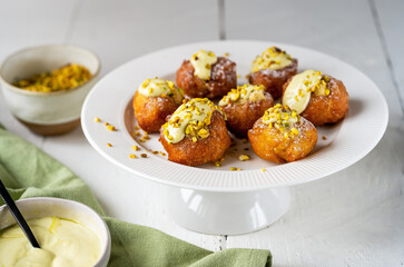Frittelle with Pistachio Cream on Cake Stand