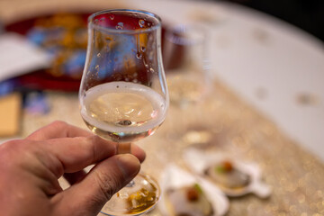 Small tasting glass of sparkling wine champagne on winter festival in December, Avenue de Champagne, Epernay, Champagne region, France