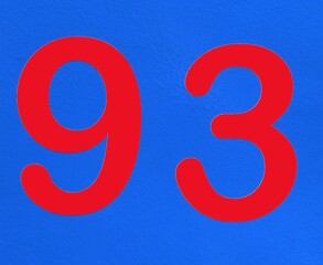 A red number plaque, showing the number ninety-three, 93.