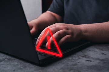 Woman use laptop with hologram warning sign for notification error. Programmer, developer and...