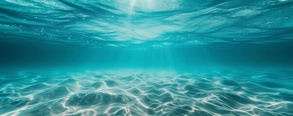 Mesmerizing underwater view as sunlight filters through crystal-clear blue ocean water, creating patterns