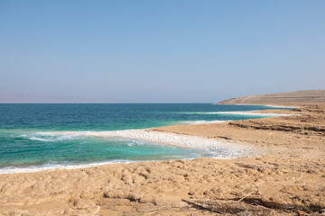 Fototapeta na wymiar Rocky Beach With Salt Deposits in the Dead Sea, Jordan