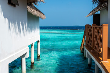 View of the sea and islands on the horizon, between two white houses.