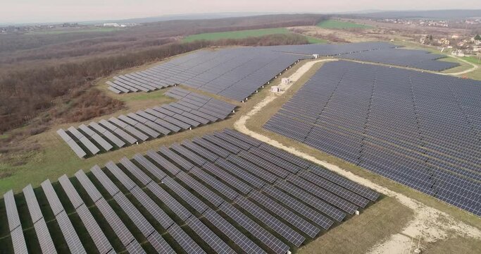 Aerial footage of photovoltaic solar farm. Solar farm power station from above. Ecological renewable energy.