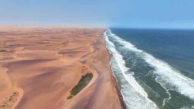 Aerial of the desert sand dunes plunging into the Atlantic Ocean, Iona National Park, Angola, Africa