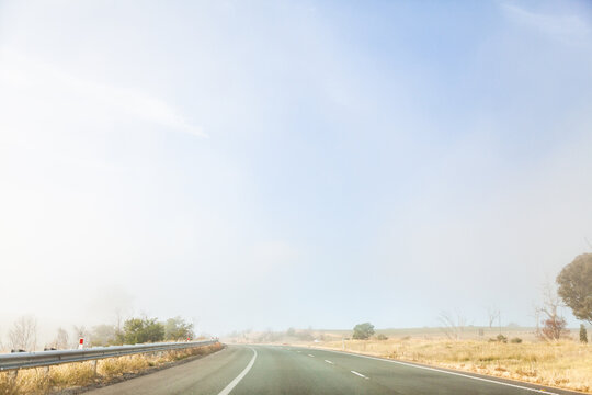 Changing weather conditions on highway sunlight and fog